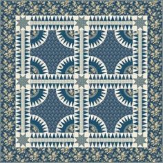 a blue and white quilt with an intricate design on the front, two squares are shown