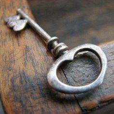 an old key on a wooden table with a quote from the german prove's