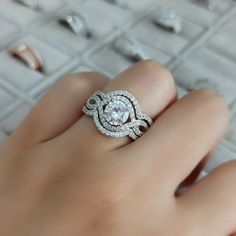 a woman's hand with a diamond ring on it