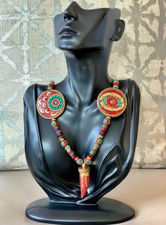 Absolutely Stunning Statement Necklace featuring a wide variety of Pendants & Beads: -1 Vintage Red Tibetan Tusk Pendant made of Bone & Horn (2 inches long) -2 Tibetan Circular Coin Beads with Turquoise & Coral Inlay on Brass (1.7 inches in Diameter) -10 Tibetan Beads with Turquoise & Coral Inlay on Brass -Red Czech Glass Rondelle Roller Beads -Light Green/Turquoise Picasso Finish Czech Glass Roller Beads -Mykonos Ceramic Washer Beads in: Red, Metallic Red, mixed Turquoise, and m Tusk Pendant, Ceramic Beads Necklace, Bone Horn, Geometric Studs, Big Gifts, Custom Pendants, Beaded Statement Necklace, African Jewelry, Coral Turquoise