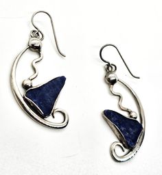 Abstract Modernist Blue Sodalite gemstone handcrafted vintage sterling silver drop earrings. Good vintage condition with little to no signs of normal vintage wear. Stamped Sterling on the back of each earring. Blue sodalite polished slab set in unique sterling silver setting with handcrafted abstract setting. Hook fastening. Acid tests positive for sterling silver. Earrings measure 2 inches tall and 7/8ths of an inch wide. Unique Blue Sterling Silver Earrings, Unique Blue Earrings Stamped 925, Artistic Blue Sterling Silver Earrings, Blue Sterling Silver Earrings With Polished Finish, Blue Vintage Sterling Silver Earrings, Earring Inspiration, Blue Sodalite, Sterling Silver Drop Earrings, Earrings Inspiration