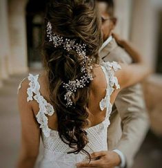 the back of a woman's head wearing a wedding dress