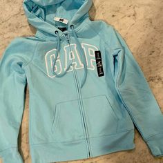 Girls Sporty Gap Tops For Spring, Sporty Blue Gap Tops, Gap Light Blue Cotton Tops, Light Blue Tops For School In Spring, Trendy Blue Gap Tops, Fitted Blue Gap Tops, Mint Green Jacket, Hoodie Gap, Gap Jacket