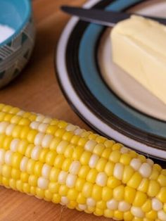 corn on the cob with butter and knife next to it