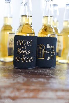 some beer bottles are sitting on a table with happy 40 years written on the labels