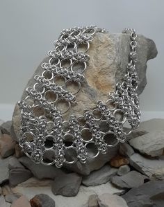 This unusual necklace is made using a byzantine weave and graduated rings. A simply stunning necklace to wear. It's made with bright aluminium rings, in beautiful sparkling silver. There are more than 900 rings in this piece, put together one at a time. (That's a lot of hours!) The necklace is 43cm long, including the stainless steel lobster claw clasp. The necklace is curved and designed to sit just on the collar bone. The main design of the necklace tapers towards the back and joins with a del Silver Chainmail Necklace, Chainmail Necklace, Unusual Necklace, Chain Maille Jewelry, Collar Bone, Gothic Necklace, Chain Mail, Wedding Jewellery Necklace, Everyday Luxuries