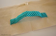 a piece of fabric with polka dots on it sitting on top of a cardboard bag