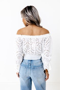 Stay dainty in our elegant white 'Love Out Loud' top featuring intricate eyelet detailing, a straight elastic off-shoulder neckline with a tie closure, loose 3/4-length drop sleeves with flared cuffs, and a relaxed silhouette that end in a straight elastic hemline! on products Measurements S : Bust 32", Length 16", Sleeve Length 17.5", Waist 20-22". M : Bust 34", Length 16.5", Sleeve Length 17.5", Waist 22-24". L : Bust 36", Length 17", Sleeve Length 18.5", Waist 24-26". White Eyelet Feminine Top, White V-neck Smocked Top, Spring V-neck Eyelet Top, Love Out Loud, Cotton Eyelet V-neck Top, Eyelet Top, Out Loud, Off Shoulder, Sleeve Length