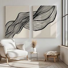 two black and white paintings in a living room