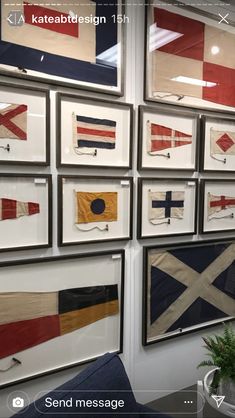 many framed flags are hanging on the wall