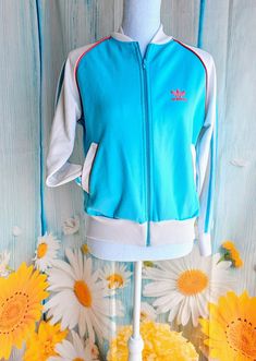 Wonderful retro track jacket by Adidas Label states size Medium - please compare to your measurements it my fit more like a modern small Measurements are taken with garment laying down flat: Underarm to underarm 21" Length from middle of neck down 22.5 87% Polyester 13% Cotton Blue Sports Track Jacket With Zipper Closure, Casual Blue Track Jacket With Zipper Closure, Blue Sporty Track Jacket With Zipper, Blue Retro Track Jacket For Sports, Retro Blue Track Jacket For Sports, Retro Blue Hooded Track Jacket, Vintage Blue Long Sleeve Track Jacket, Retro Blue Track Jacket For Streetwear, Blue Retro Track Jacket For Spring