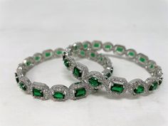 AD Silver polish bangles studded with American diamond cubic zirconia and semi-precious, Hydro Green, and cluster stones. A beautiful glamorous, AD bangles can be used on any outfit or occasions like Weddings, Birthdays, Festivals, etc. This bangle is available in different sizes. Quantity: This bangle comes in a set of 2 pieces. Disclaimer: Actual product color might slightly vary due to photography/lighting. Ad Bangles, Stone Bangles, Silver Polish, Green Stones, Stone Bangle, Photography Lighting, Bangle Designs, American Diamond, Green Stone