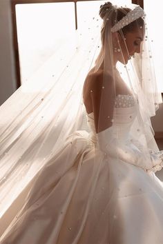 a woman wearing a wedding dress and veil