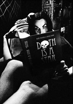 black and white photograph of a woman reading a book