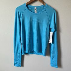 Nwt Lululemon Swiftly Tech Long Sleeve Shirt 2.0 *Race Length Kayak Blue Light/Kayak Blue Light Size 8 Blue Go-dry Long Sleeve Activewear, Blue Long Sleeve Go-dry Activewear, Blue Athleisure Activewear With Thumbholes, Blue Long Sleeve Running Activewear, Blue Long Sleeve Running Tops, Lululemon Swiftly Tech Long Sleeve, Swiftly Tech Long Sleeve, Lululemon Shirt, Sporty Blue Tops With Thumbholes