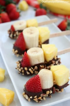 banana split bites with chocolate and strawberries on them