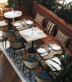 an overhead view of a restaurant with tables, chairs and place settings on the table