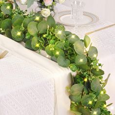 the table is decorated with greenery and flowers