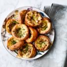 a white plate topped with mini breads on top of a table