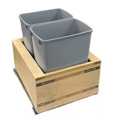 two plastic containers are stacked on top of each other in a wooden box with drawers