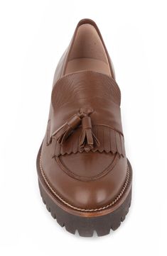 A lug sole lends an extra-toothy bite to a street-savvy leather loafer with a classic tassel detail on the fringed vamp. 1" heel Removable, cushioned insole with arch support Leather upper and lining/rubber sole Made in Spain Classic Leather Tassel Loafers With Fringe, Leather Tassel Loafers With Flat Heel, Leather Loafers With Tassels And Almond Toe, Leather Almond Toe Loafers With Tassels, Leather Tassel Loafers With Fringe For Work, Fall Tassel Loafers With Rubber Sole And Almond Toe, Fall Workwear Tassel Loafers With Brogue Detailing, Fall Tassel Loafers With Leather Sole And Almond Toe, Leather Oxfords With Tassels And Round Toe