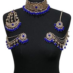 Handcrafted royal blue antique golden kundan Indian wedding / bridal jewellery set. Set includes- Earrings with multilayer pearl sahara  Choker necklace Jhumar Tikka  Our choker is adjustable with a dori at the back giving you a comfortable fit. It comes with elegant kundan earrings with pearl detail, tikka and jhumar with hooks.  The subtle glimmer of the kundan with elegant pearl detail makes this jewelry set a truly head turning piece, a must have for every jewellery box.  Our ethnic jeweller Blue Chandbali Kundan Necklace For Wedding, Blue Kundan Necklace For Diwali Wedding, Blue Kundan Necklace For Wedding And Diwali, Blue Kundan Necklace For Wedding, Heavy Gold Lehenga For Party, Blue Kundan Necklace For Wedding And Festivals, Blue Heavy Jewelry For Wedding, Heavy Blue Jewelry Sets For Wedding, Gold Temple Jewelry Style Lehenga For Parties