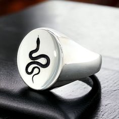 Silver Serpent Signet Ring , Unisex Snake Signet Ring , Snake Engraving Signet Ring , Oval Serpent Snake Ring , Gift For Him , Gift For Her  ★Item Details * Gender : Male / Female * Material : 925K Sterling Silver * Total weight :  7 Grams ✔ Ready to Ship in 1-2 Business Days .. ✔ Shipped to the Worldwide 1-5 business days with free shipping... ✔ The product will be sent to you with a handmade wooden box to avoid any damage during shipping... ✔ Visit our store, browse other Men's jewelry, silver Symbolic Adjustable Oval Engraved Ring, Symbolic Oval Engraved Adjustable Ring, Symbolic Engraved Adjustable Oval Ring, Symbolic Stamped Oval Rings, Symbolic Oval Stamped Rings, Snake Engraving, Serpent Snake, Handmade Wooden Boxes, Signet Rings