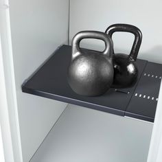 a metal kettle sitting on top of a shelf