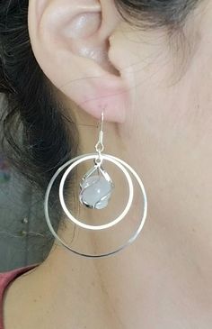 New  Handmade  White Quartz Hoop Earrings  ♡ Beautiful white quartz orbs wrapped in a spiral cage of silver dangle in the middle of two polished hoops. ♡ Ear hooks stamped. 925 ♡ Dangle length measures 2 inch ~ Ships with a gift box Ships within 24 hours of purchase Monday-Saturday Gift Packaging & Messages: Your item will be lovingly packaged and labeled as a handmade item.  Item's that ship with gift boxes are stated in the description. Handwritten gift notes available, just include a gift mes White Wire Wrapped Dangle Hoop Earrings, Nickel Free White Circle Hoop Earrings, Nickel-free White Circle Hoop Earrings, White Wire Wrapped Small Hoop Earrings, White Wire Wrapped Small Hoop Jewelry, White Metal Round Hoop Earrings, Wire Wrapped Round Crystal Earrings, Wire Wrapped Round Metal Crystal Earrings, Wire Wrapped Metal Crystal Earrings