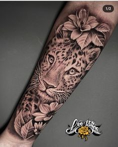 a black and white photo of a leopard with flowers on it's arm