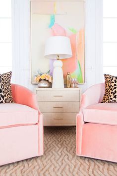 an instagram page with two pink chairs in front of a white table and lamp