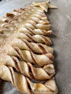 an apple pie is lined up on a baking sheet