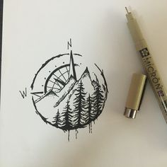 a pen and marker sitting on top of a piece of paper next to a drawing