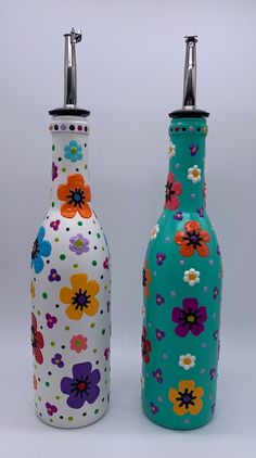 two colorful vases with flowers painted on them