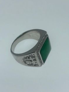 Large green nephrite jade Ornate German Silver Vintage ring, does not tarnish, NOT sterling Has Chinese lettering for luck on the sides. Sizes 8, 9 10 or 11 All rings are shipped in a nice gift box. Check out our over a THOUSAND great reviews Engraving is $4 per letter and is not always perfect depending on the piece. It can take a few days if the jeweler is busy. This is payable to Paypal Judithsltd@gmail.com Green Rectangular Signet Ring For Formal Occasions, Symbolic Green Gemstone Jewelry, Green Gemstone Signet Ring For Anniversary, Green Signet Ring For May Birthstone, Green Emerald Cut Signet Ring With Polished Finish, Green Emerald-cut Signet Ring With Polished Finish, Vintage Green Signet Ring With Polished Finish, Green Signet Ring With Polished Finish For May Birthstone, Classic Green Engraved Signet Ring