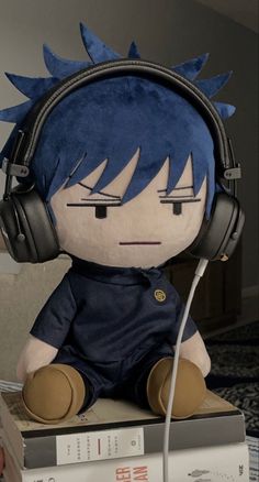 a stuffed toy with headphones on top of books