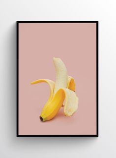 a single banana on a pink background