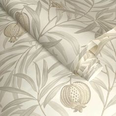 the wallpaper is white and grey with leaves on it's sides, as well as a roll of tape