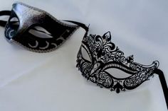 This is a gorgeous combination for his and hers masquerade masks. One is Silver and black which we put a dash of black glitter and silver around the eyes also sealed it with a beautiful silver trim! Part of the pair is beautiful laser cut metal mask with beautiful crystals and a black ribbon.I will combine a his and hers mask from any of my masquerade masks that fit both! I can combine my machine embroidered masks too that I make and change any color of my machine embroidered masquerade masks.Pl Black Masquerade Mask For Halloween Wedding, Elegant Black Mask For Costume Party, Elegant Black Masquerade Mask For Halloween, Black Formal Eye Mask Masquerade, Elegant Black Masks And Prosthetics For Party, Elegant Black Party Masks And Prosthetics, Elegant Black Masks And Prosthetics For Evening, Black Masquerade Mask For Wedding Carnival, Elegant Black Eye Mask For Masquerade