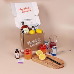 a box filled with drinks and condiments next to a cutting board