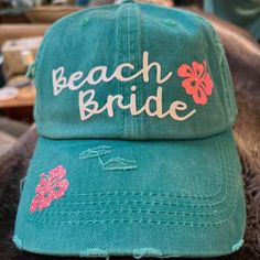 Beach Bride!  Distressed Baseball Cap, Pool Hat, Beach Hat, Summer Hat, wear on honeymoon Design is in super cute glitter! Shown in Turqouise    Also available in: Black, Pink, white and navy Size: One Size Fits Most Content: 100% Cotton Feature:     Ponytail Baseball Cap is a distressed canvas cap with an opening in the back to allow you to wear your hair in a high ponytail.          Perfect for staying stylish while out in the sun, this trendy cap will coordinate with any outfit! All outfits and ball caps are MADE TO ORDER in a smoke-free home. Custom orders are welcome, message me for a quote! Green Snapback Beach Hat, Green Baseball Cap For Beach, Beachy Cap Hat, One Size Fits Most, Green Curved Brim Baseball Cap For Beach, Green Curved Brim Baseball Cap For The Beach, One Size Vacation Mini Cap Hat, Green Mini Hats For Beach, Green Baseball Cap For Vacation, Green Mini Hats For The Beach