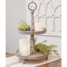 three tiered tray with candles and greenery