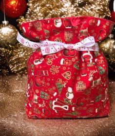 a red christmas gift bag sitting on top of a table