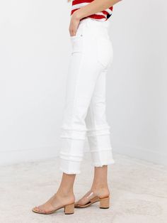 A more trend forward take on denim for the summer season! These unique and updated denim jeans feature a cropped length and flared leg opening, adding an extra touch of style to your look. The frayed tiered design and crisp white wash give them a trendy edge that will make you stand out in any crowd. Elevate your wardrobe today! A fun way to update a classic look. Liverpool Cropped length Frayed tiered accents Crisp white coloration 69% Cotton, 24% Modal, 6% Polyester, 1% Elastane Rise: 8.5" Ins Summer Flare Jeans With Frayed Hem, White High Rise Flare Jeans With Frayed Hem, White High-rise Flare Jeans With Frayed Hem, White High Rise Stretch Cropped Jeans, Chic Denim Cropped Jeans With Frayed Hem, Chic Cropped Denim Jeans With Frayed Hem, White High Waist Flare Jeans With Frayed Hem, White High-waist Flare Jeans With Frayed Hem, Trendy Flared Cropped Jeans