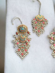 This multani work thapa kundan tikka and jhumka earrings set is gorgeous and very versatile to wear. The gold plating is traditional and the colors will match with any type of outfit. Authentic Indian, Jhumka Earrings, Earrings Set, Indian Jewelry, Gold Plating, Earring Set, Gold Plate, Multi Color, Plating