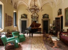 a living room filled with furniture and a grand piano