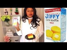 a woman holding a box of puffy corn muffins next to a shelf