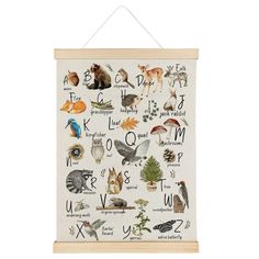 a white wall hanging with animals and letters on it