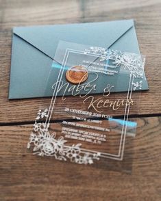 an envelope and some cards on a wooden table