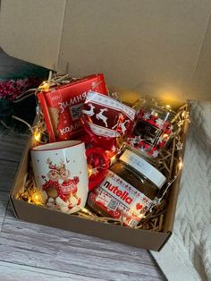 a box filled with lots of different types of food and condiments on top of a wooden table